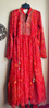 Picture of Red Bandhini dress with mirror work on yoke