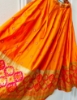 Picture of Orange and green half saree