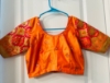 Picture of Orange and green half saree