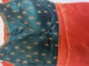 Picture of Orange tissue saree with contrast peacok color blouse
